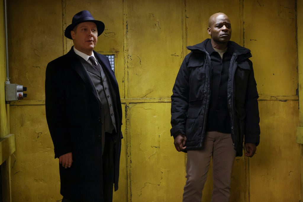 James Spader as Raymond 'Red' Reddington, Hisham Tawfiq as Dembe Zuma stand in front of a yellow background upon entering the task force location.