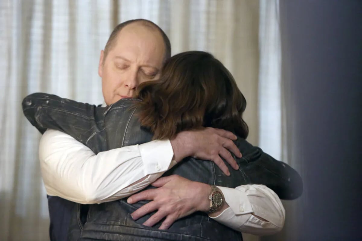 James Spader as Raymond 'Red' Reddington hugs Megan Boone as Elizabeth Keen.