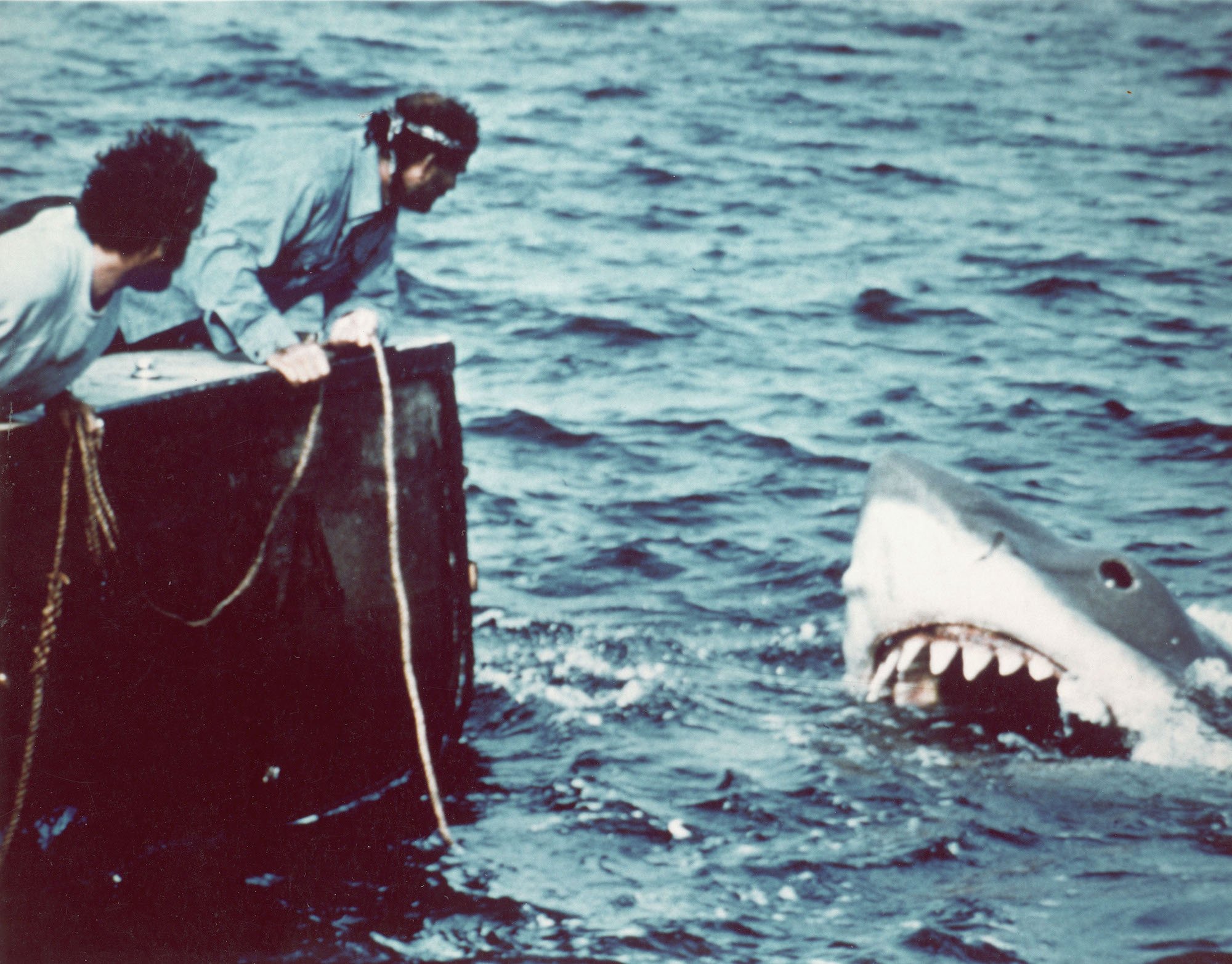 Richard Drewfuss and Robert Shaw in a boat next to a mechanical shark in the water in a scene from 'Jaws'