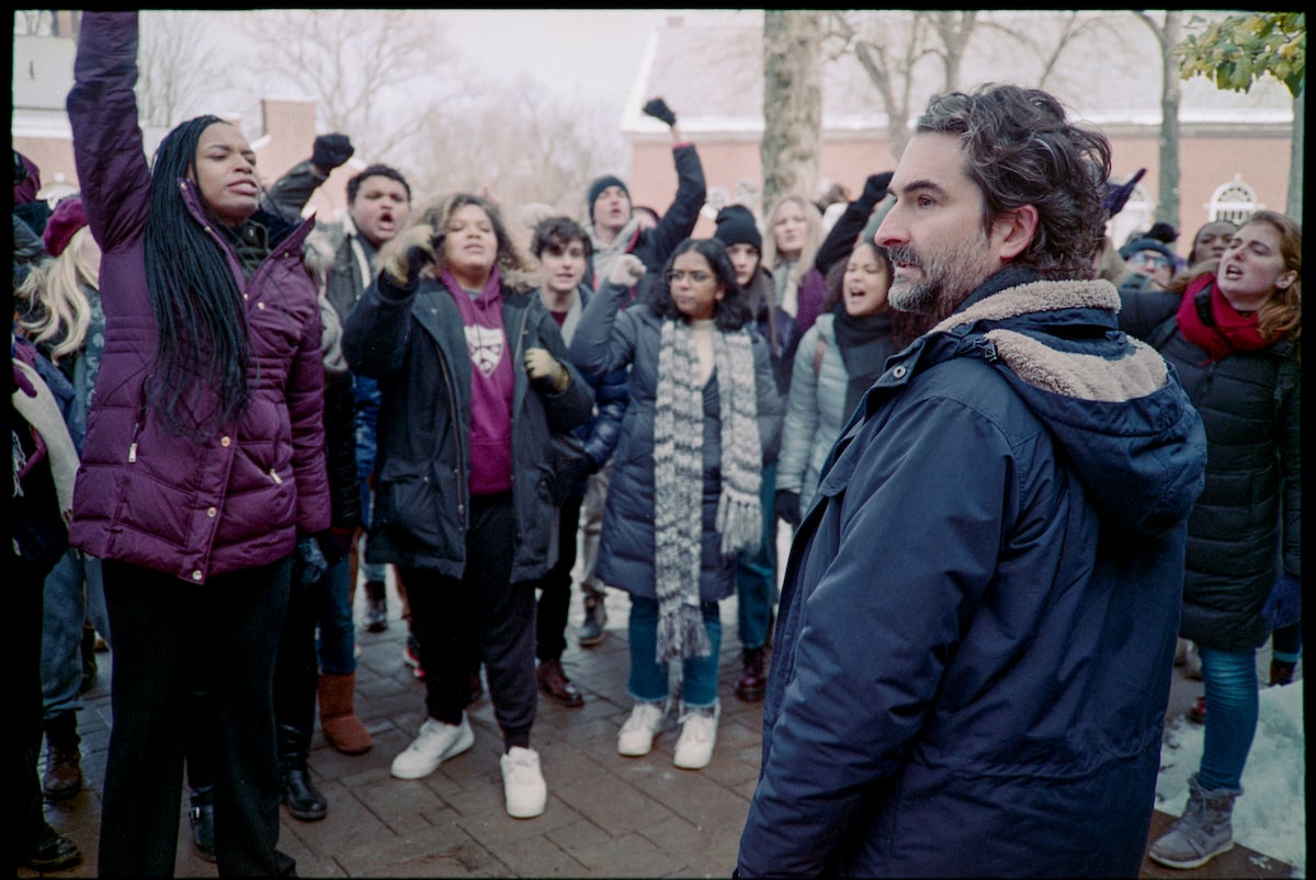 Jay Duplass wears a parka as he's surrounded by a crowd in 'The Chair' Season 1