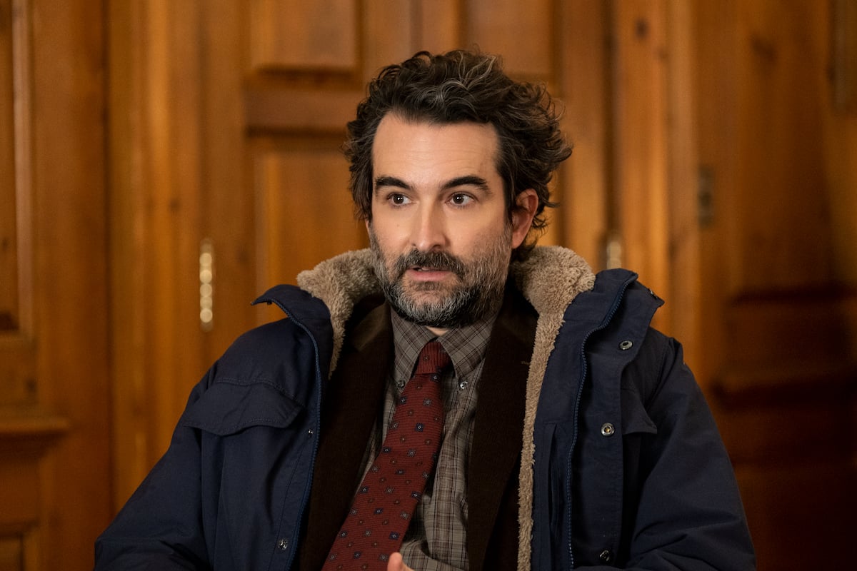 Jay Duplass wears a parka and sits in a chair as Bill Dobson in 'The Chair' Season 1 Episode 3