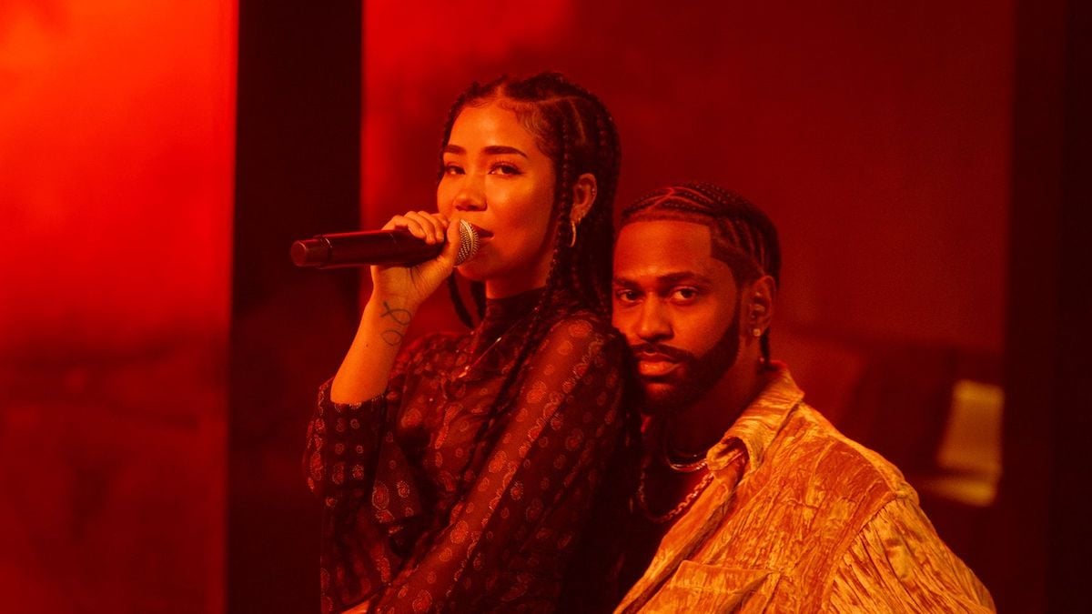 Jhené Aiko sits on Big Sean's lap as they perform a song at an award show