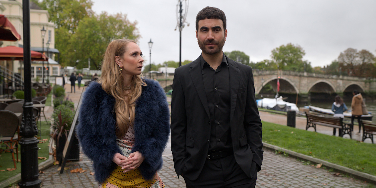 Juno Temple wearing a furry jacket and walking next to Brett Goldstein in a black suit in 'Ted Lasso' Season 1