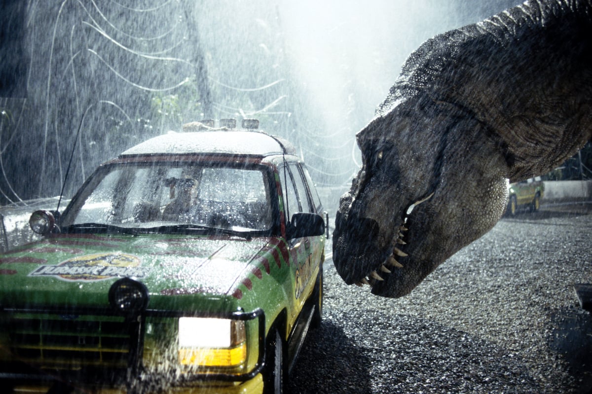 A Tyrannosaurus Rex terrorizes people trapped in a car from ‘Jurassic Park’