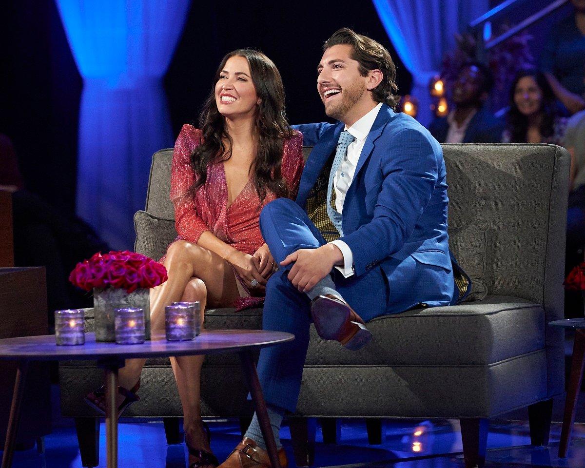Kaitlyn Bristowe, wearing a pink dress, and Jason Tartick, in a blue suit, on the set of 'The Bachelorette.'