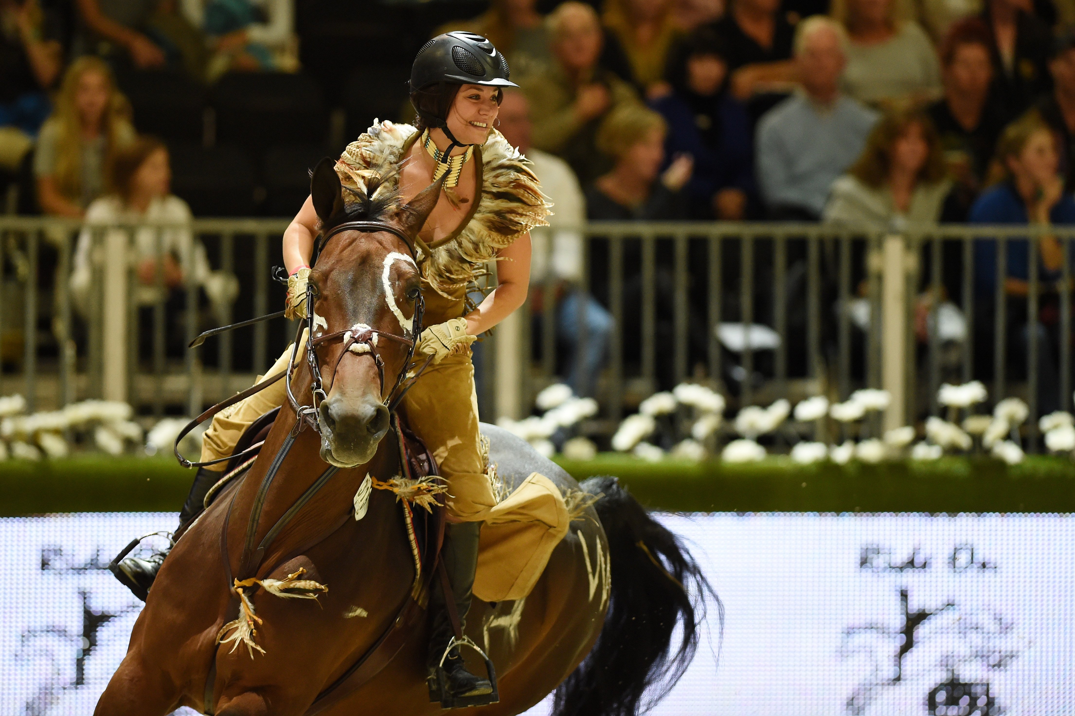 Kaley Cuoco in tan costume rides a show horse for a charity event