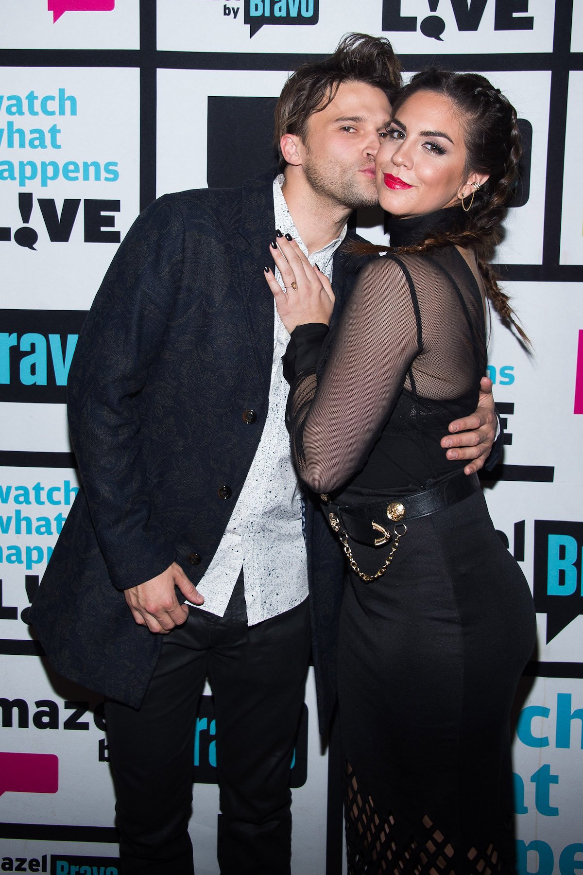 Tom Schwartz and Katie Maloney, wearing all black, get cozy at an event.