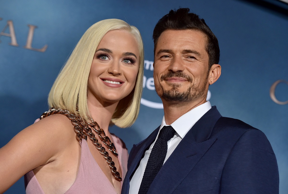 Katy Perry and Orlando Bloom smiling on the carpet together at premiere of Amazon's Carnival Row