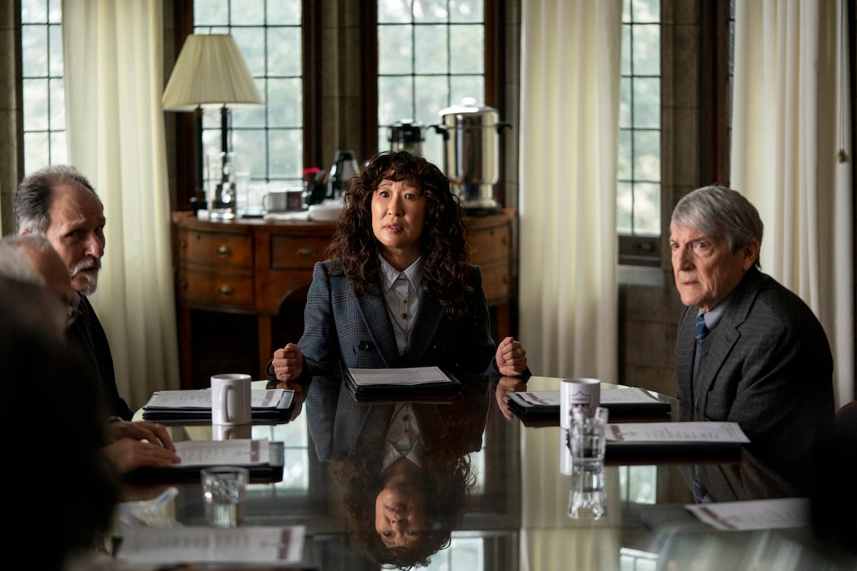 Sandra Oh sits at the head of a table next to Ken Bolden and Mark Philip Stevenson in 'The Chair' Season 1