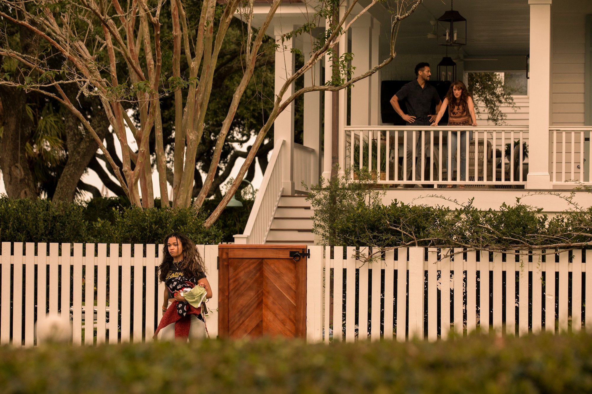 MADISON BAILEY as KIARA storming out of her parent's, played by MARLAND BURKE as MIKE, and SAMANTHA SOULE as ANNA, house in 'Outer Banks' Season 2