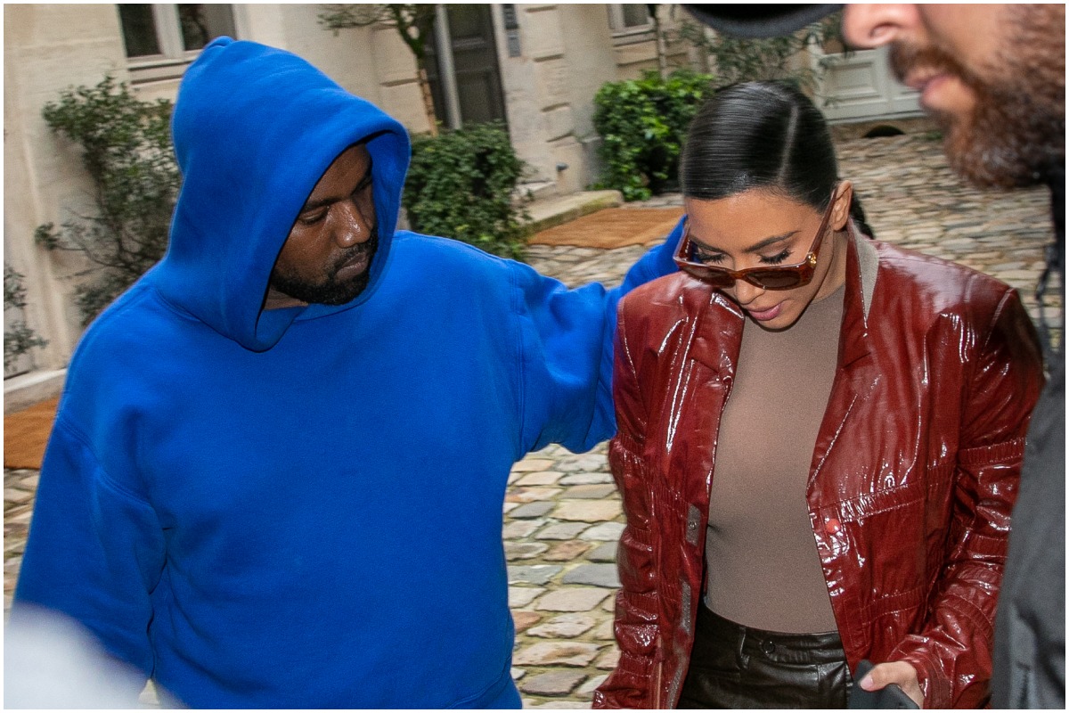 Kanye West and Kim Kardashian West walking outside in Paris
