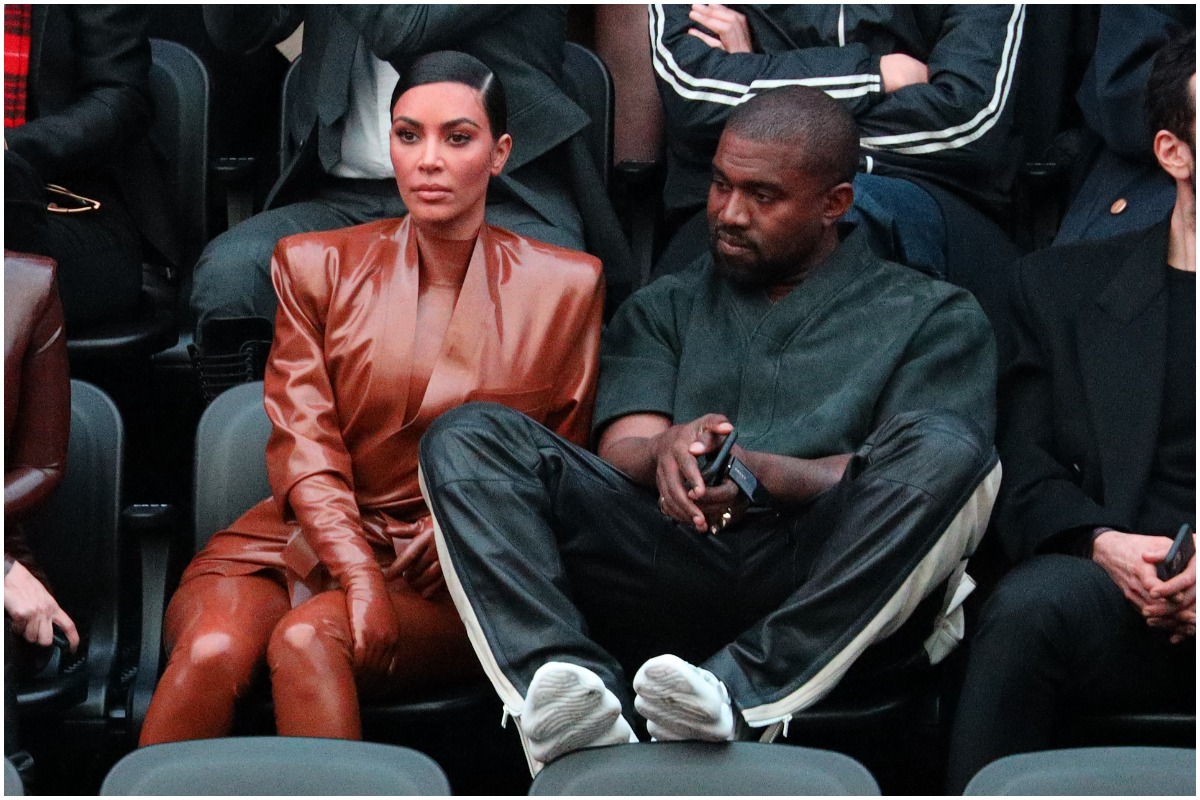 Kim Kardashian and Kanye West looking away while attending an event.