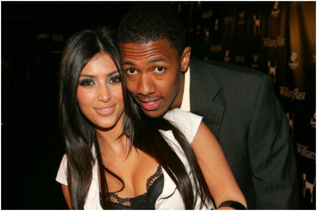 Kim Kardashian and Nick Cannon hugging and posing while attending an event.