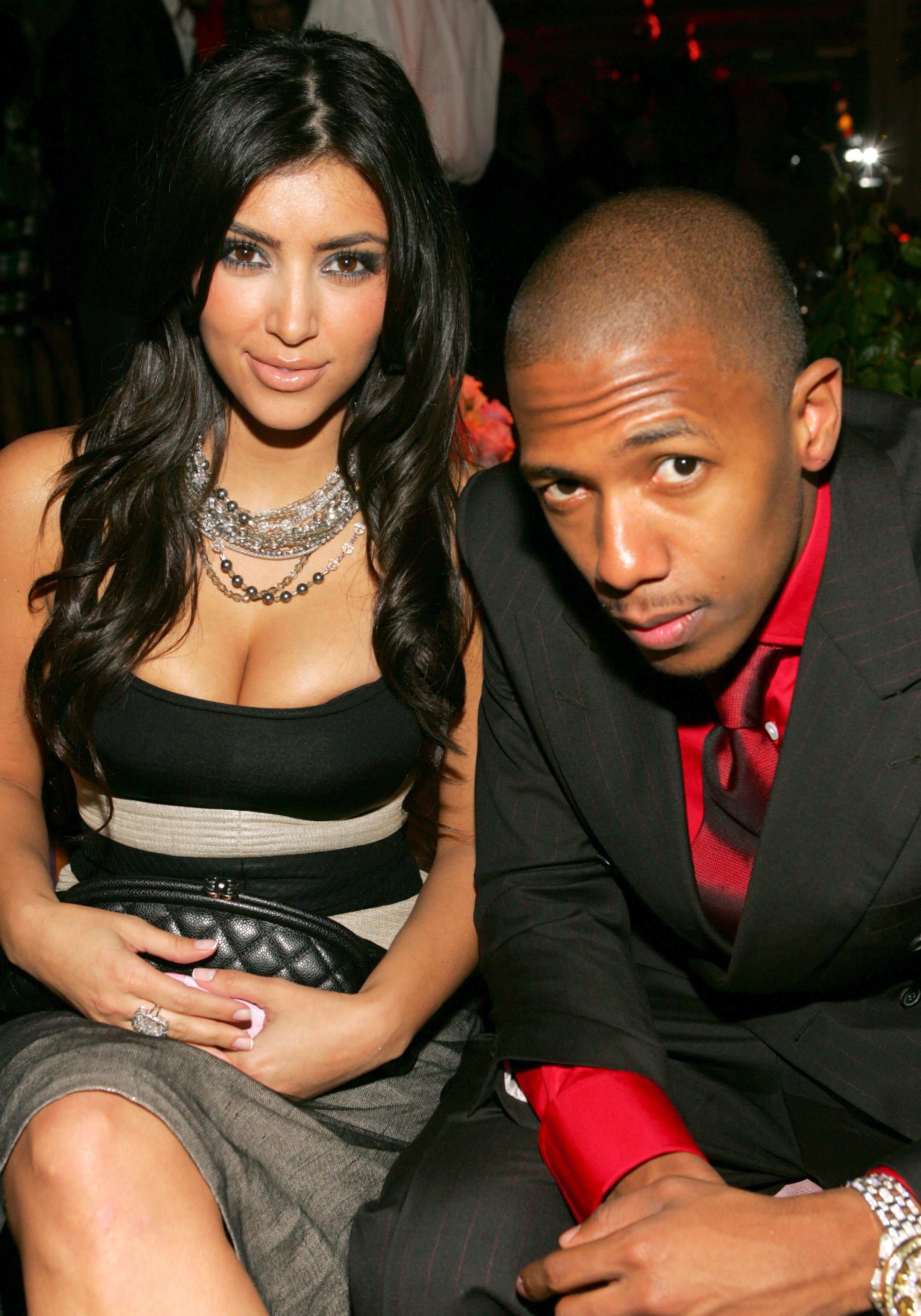 Kim Kardashian and Nick Cannon attending an event wearing a black dress and black suit.