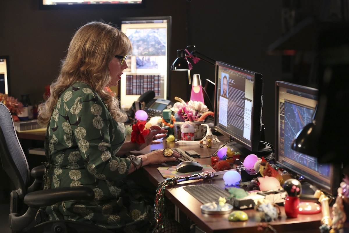 Kirsten Vangsness seated at a computer