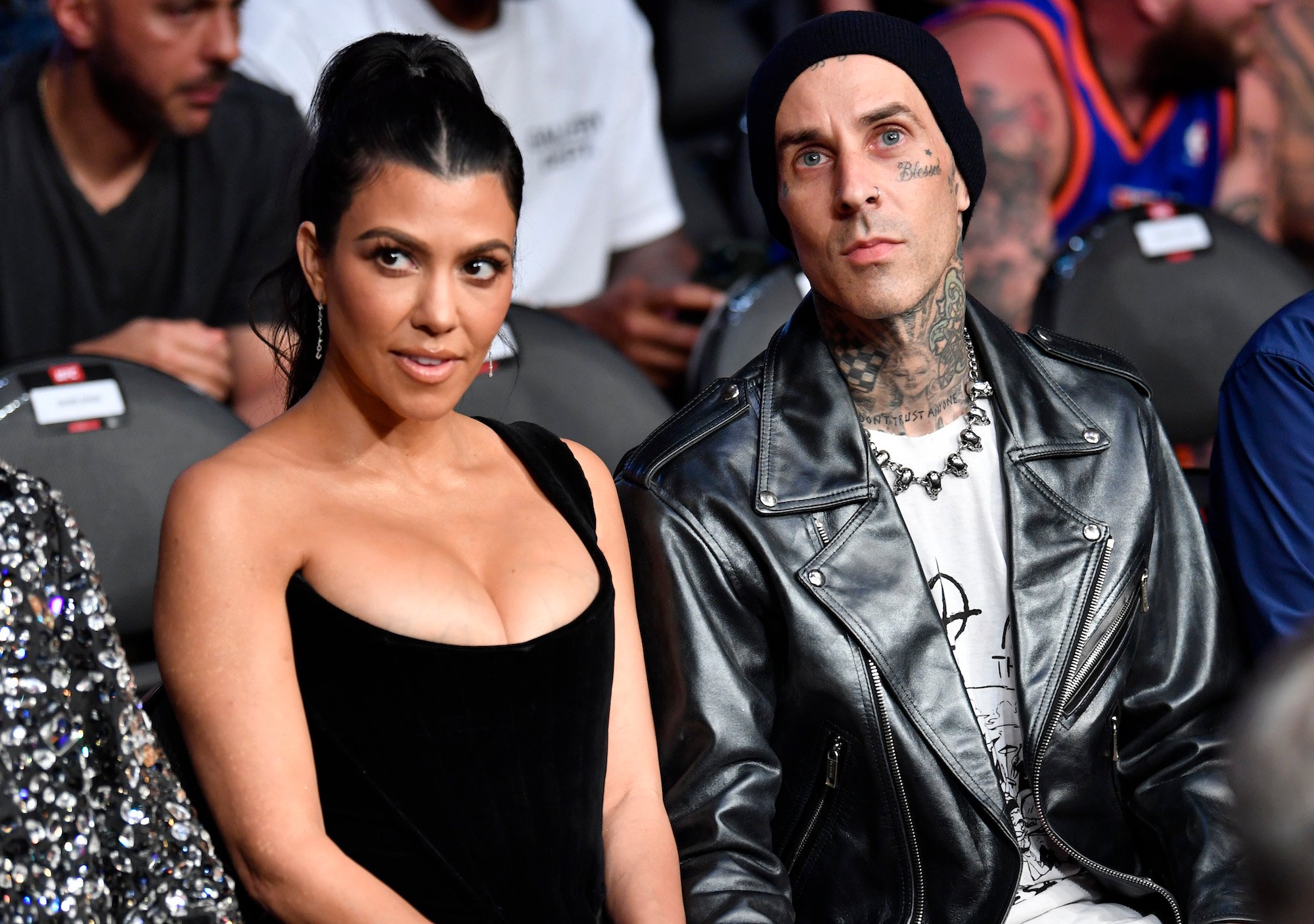 Kourtney Kardashian and Travis Barker attending UFC 264 in July 2021