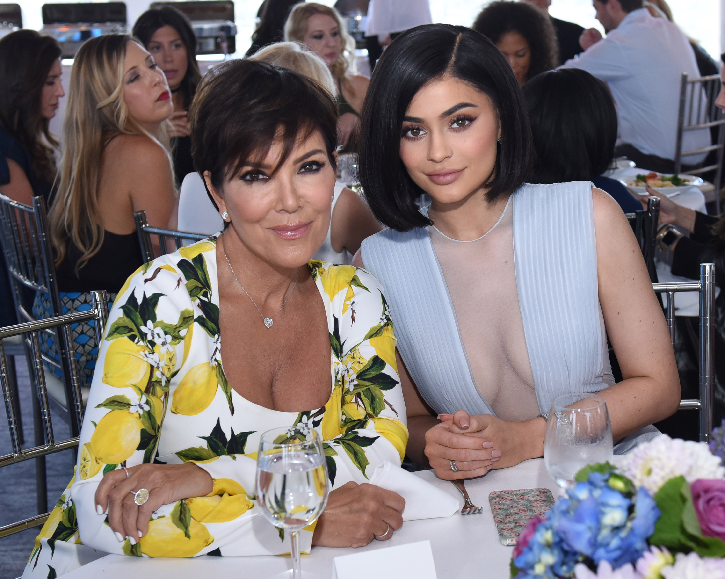 Kris Jenner in a white shirt with lemons and Kylie Jenner in a blue top