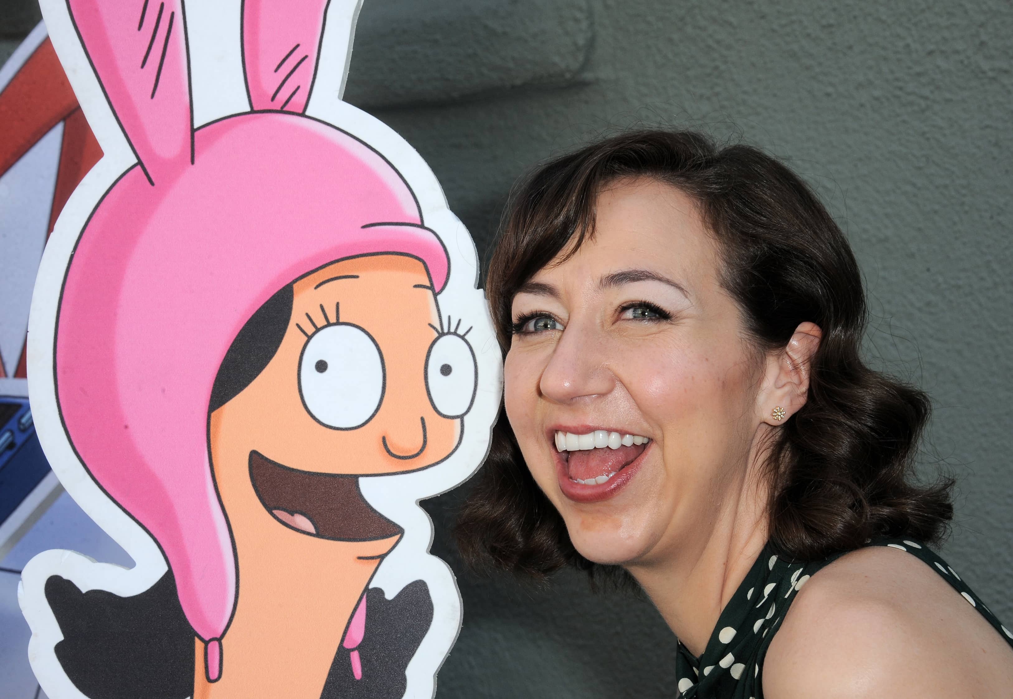 Kristen Schaal, Bob's Burgers, next to Louise Belcher cut-out