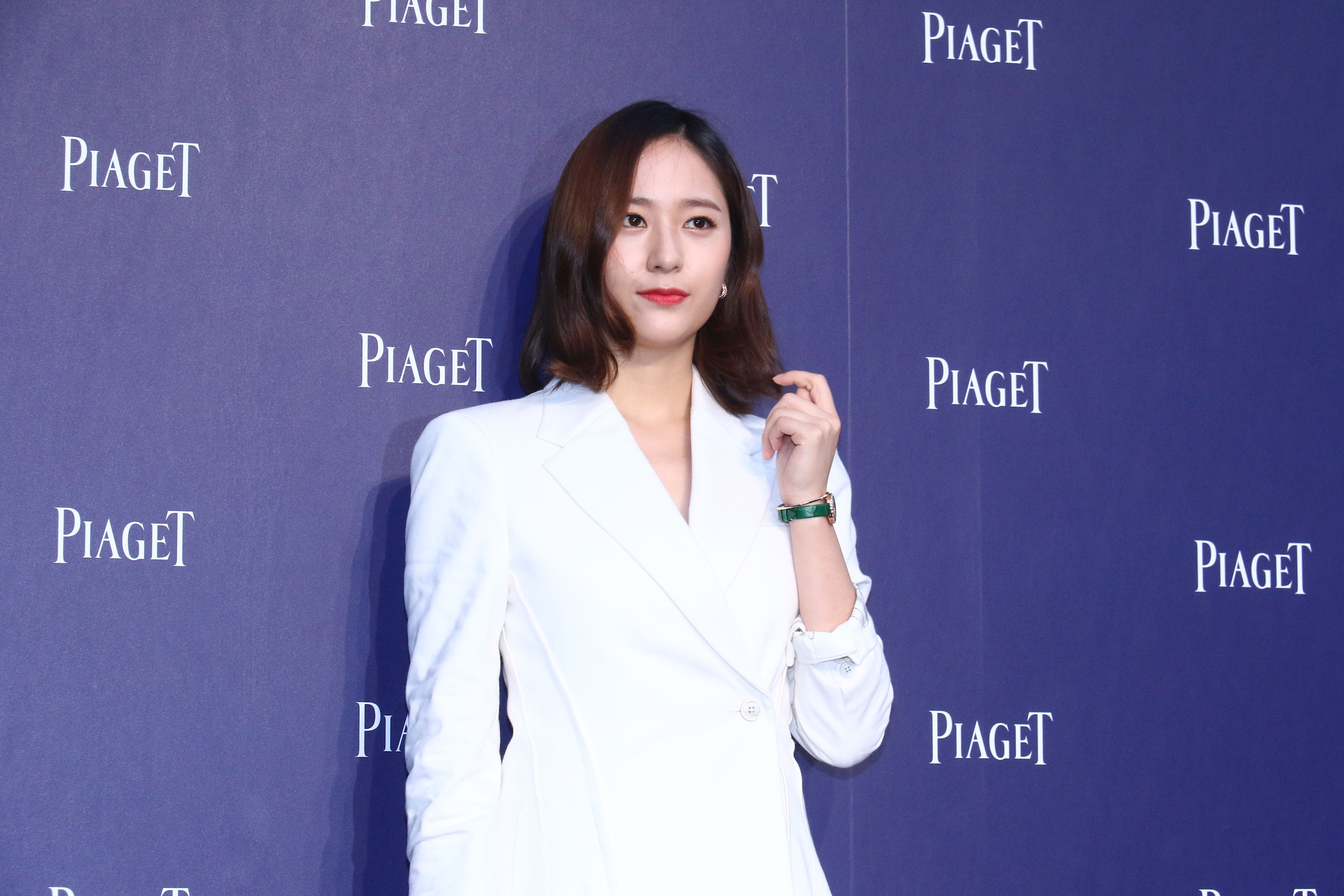 Krystal Jung 'Police University' wearing white blazer in front of purple backdrop