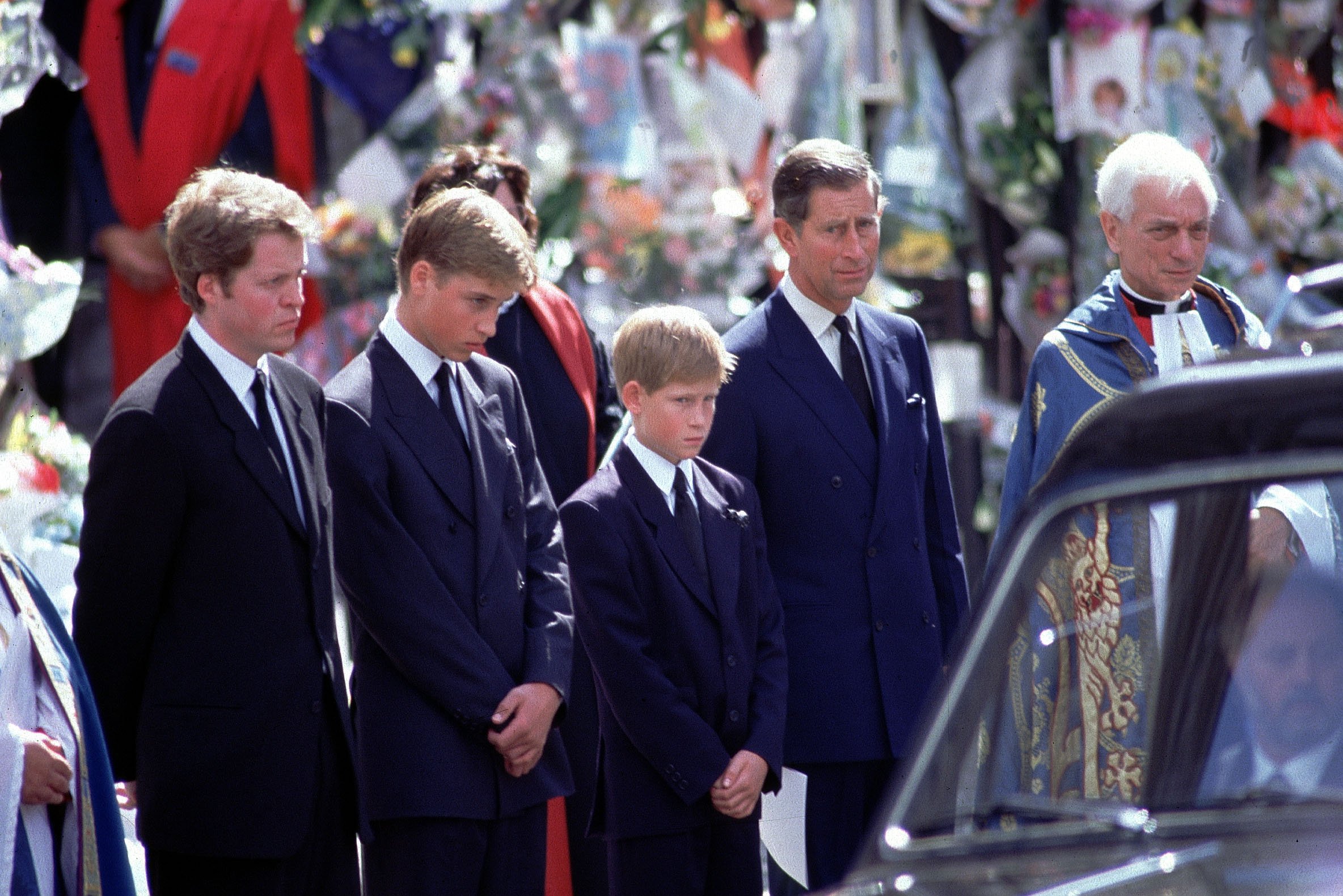 (L to R) Earl Spencer, Prince William. Prince Harry,and Prince Charles stand alongside the hearse containing the coffin of Diana
