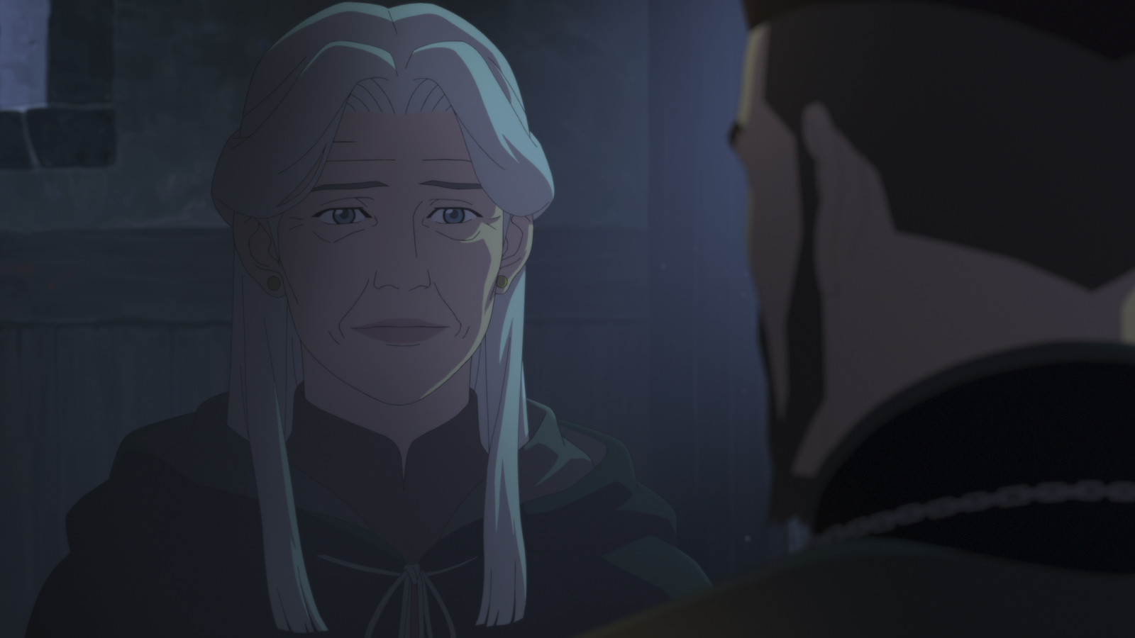 Lady Zerbst in Netflix's 'The Witcher: Nightmare of the Wolf.' She's standing in a dark room and speaking to Vesemir, whose back is turned away from the screen.