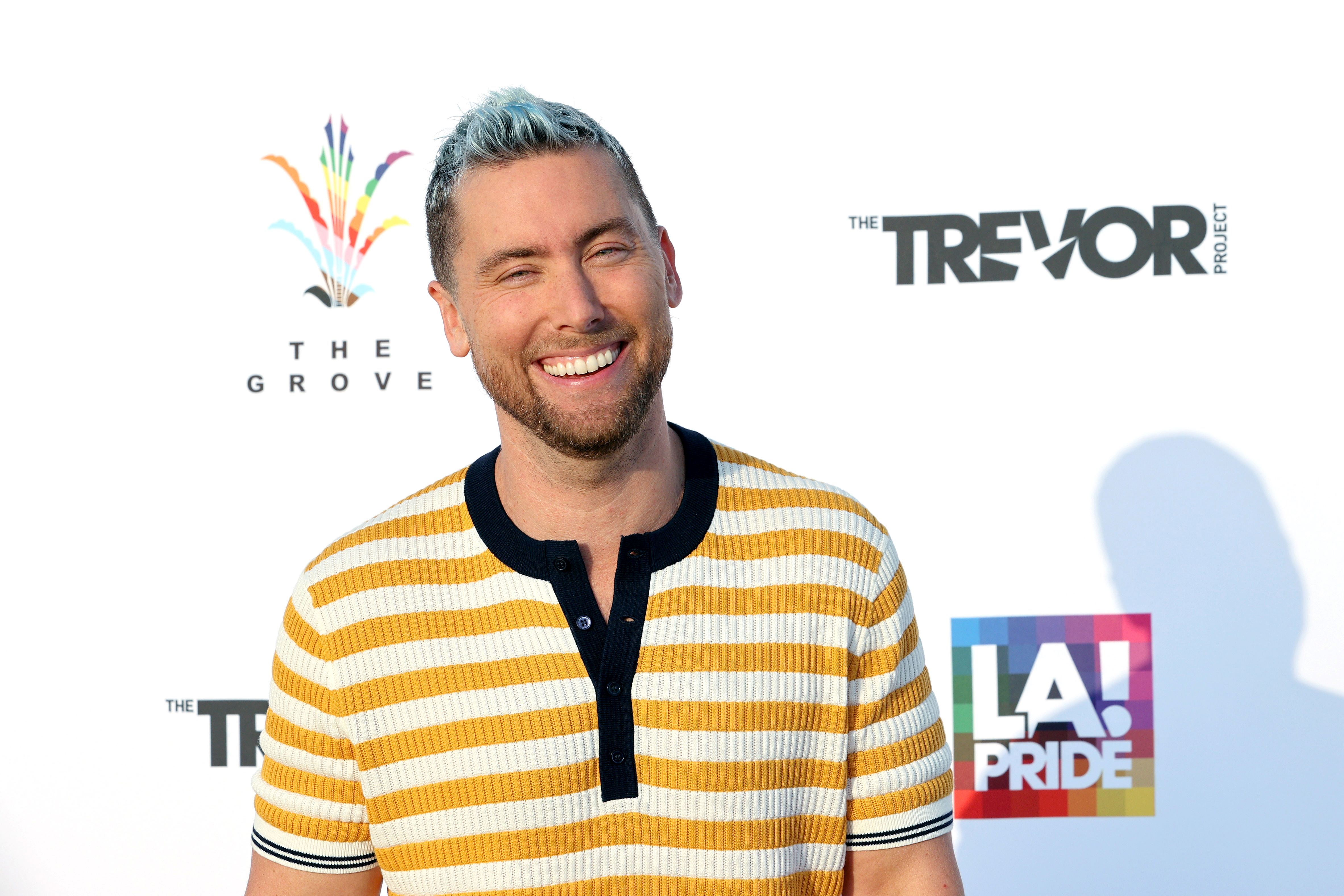 'Bachelor in Paradise' guest host Lance Bass in a yellow and white striped shirt smiling