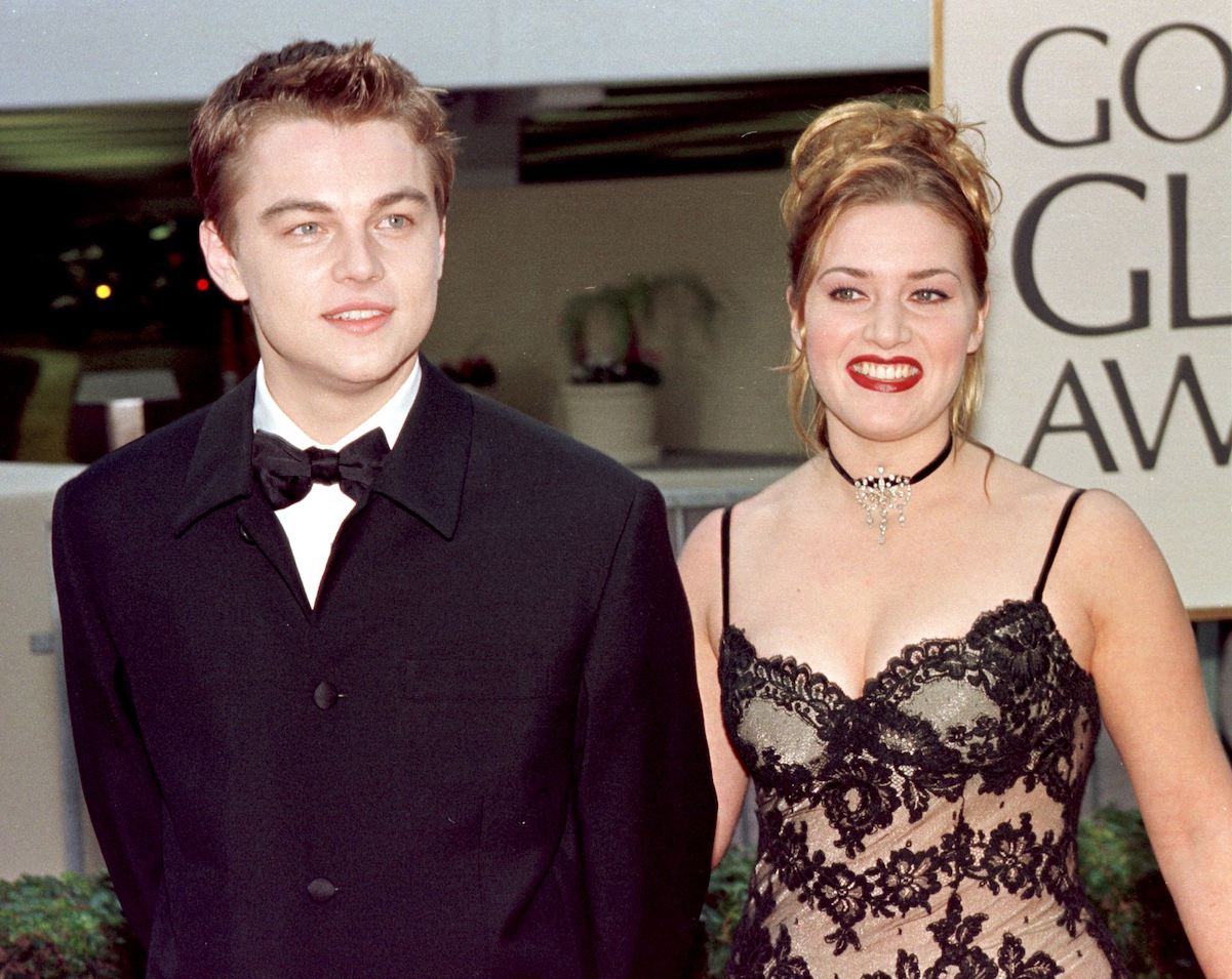 Leonardo DiCaprio and Kate Winslet walking the red carpet, smiling, holding hands