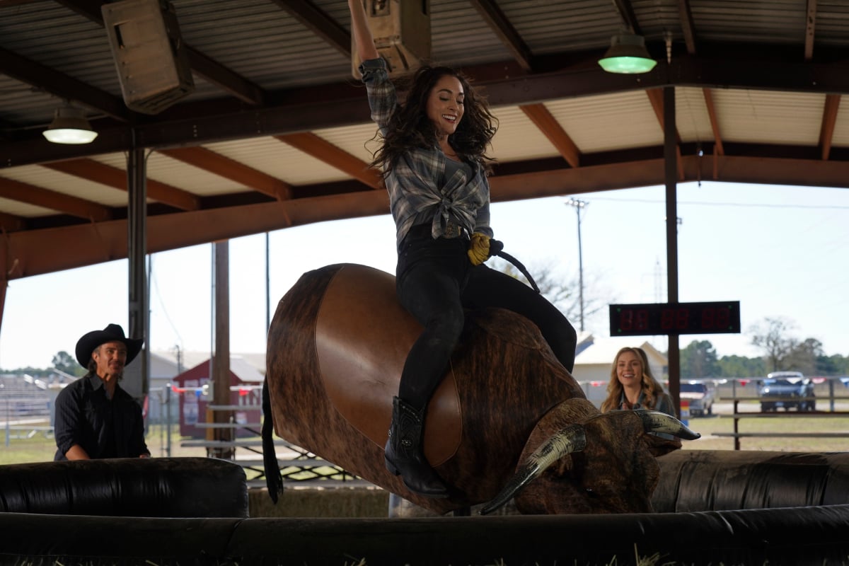 Lindsey Morgan rides a mechanical bull