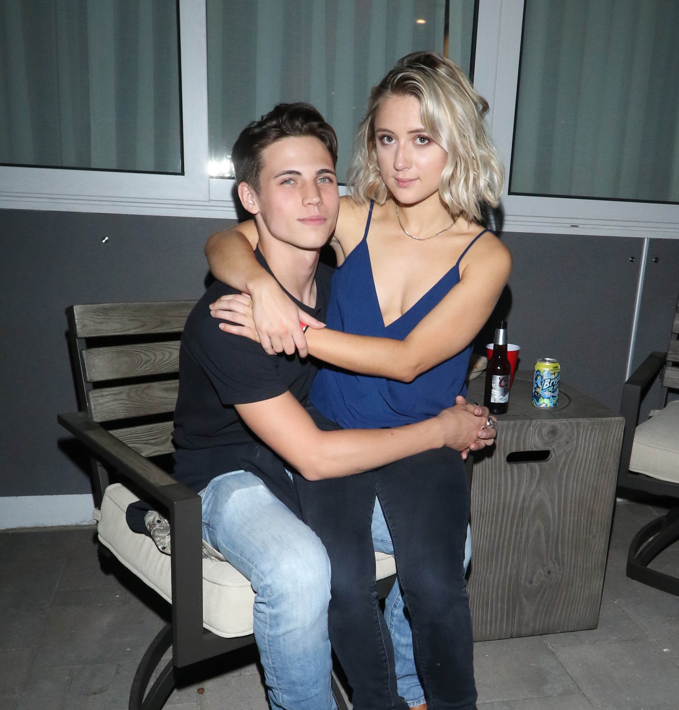 Lizze Broadway sits on Tanner Buchanan's lap