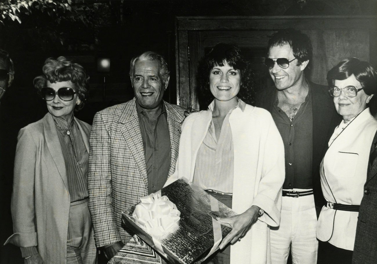 Lucille Ball, Desi Arnaz, and Lucie Arnaz at a family event.