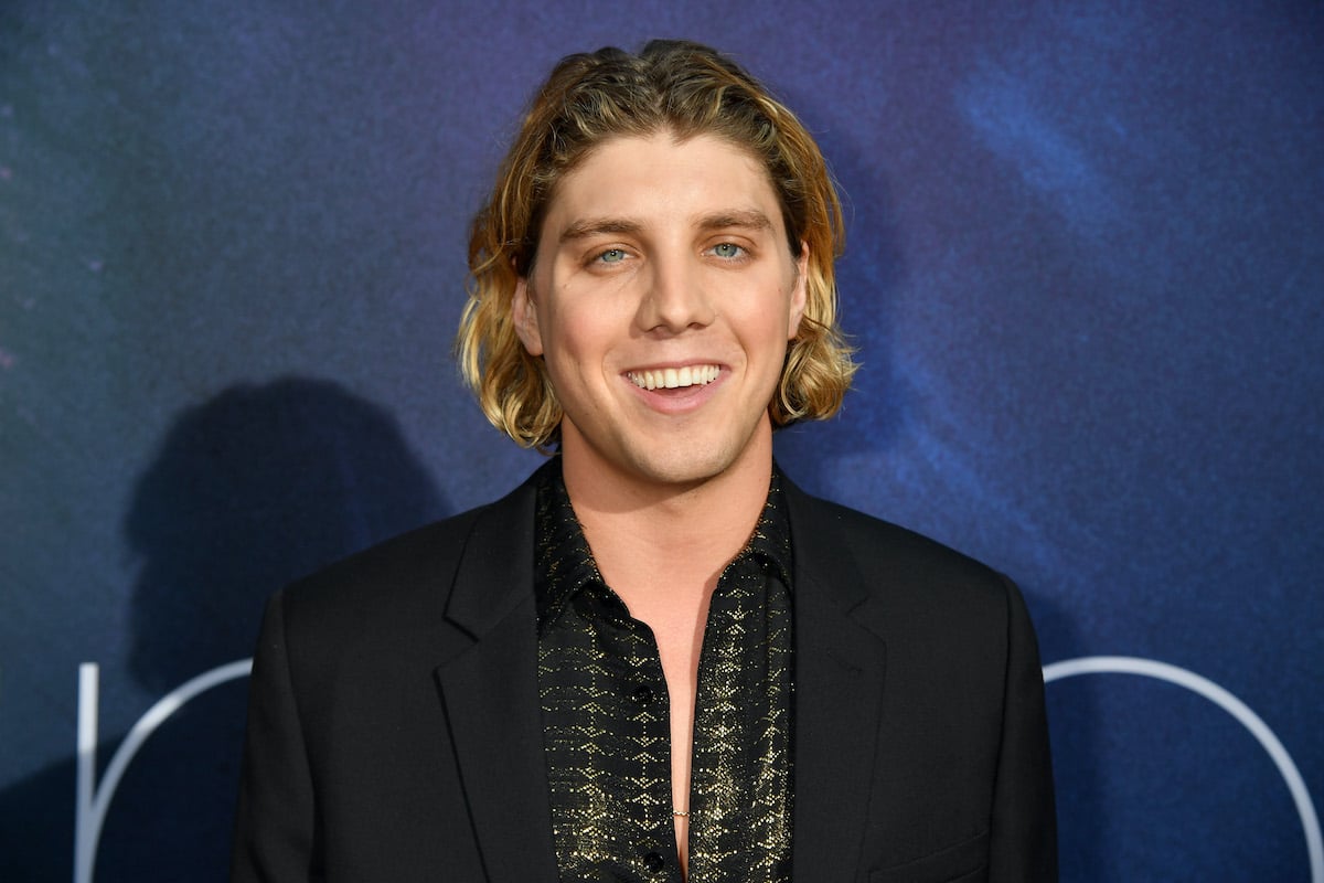 Lukas Gage attends HBO's 'Euphoria' premiere at the Arclight Pacific Theatres' Cinerama Dome on June 04, 2019 in Los Angeles. He wears a black suit with a slightly unbuttoned black shirt with gold accents and stands in front of a deep purple backdrop. Gage would later go viral for his audition video with Tristram Shapeero, a TV director he auditioned for during the COVID-19 pandemic lockdown.