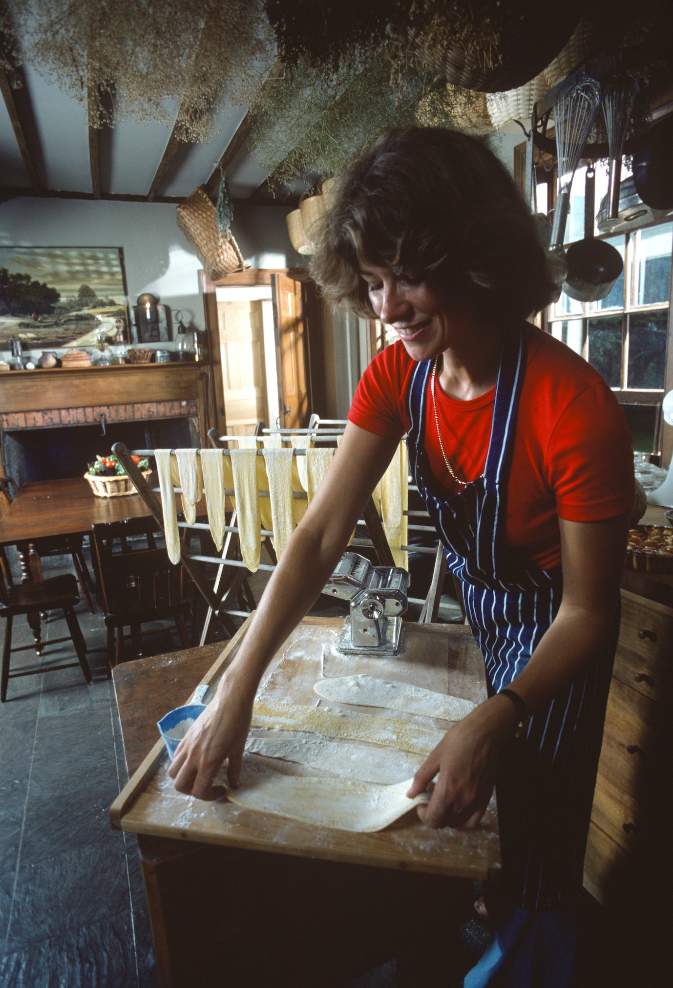 Martha Stewart in 1976 smiling and making her homemade pasta recipe in a kitchen