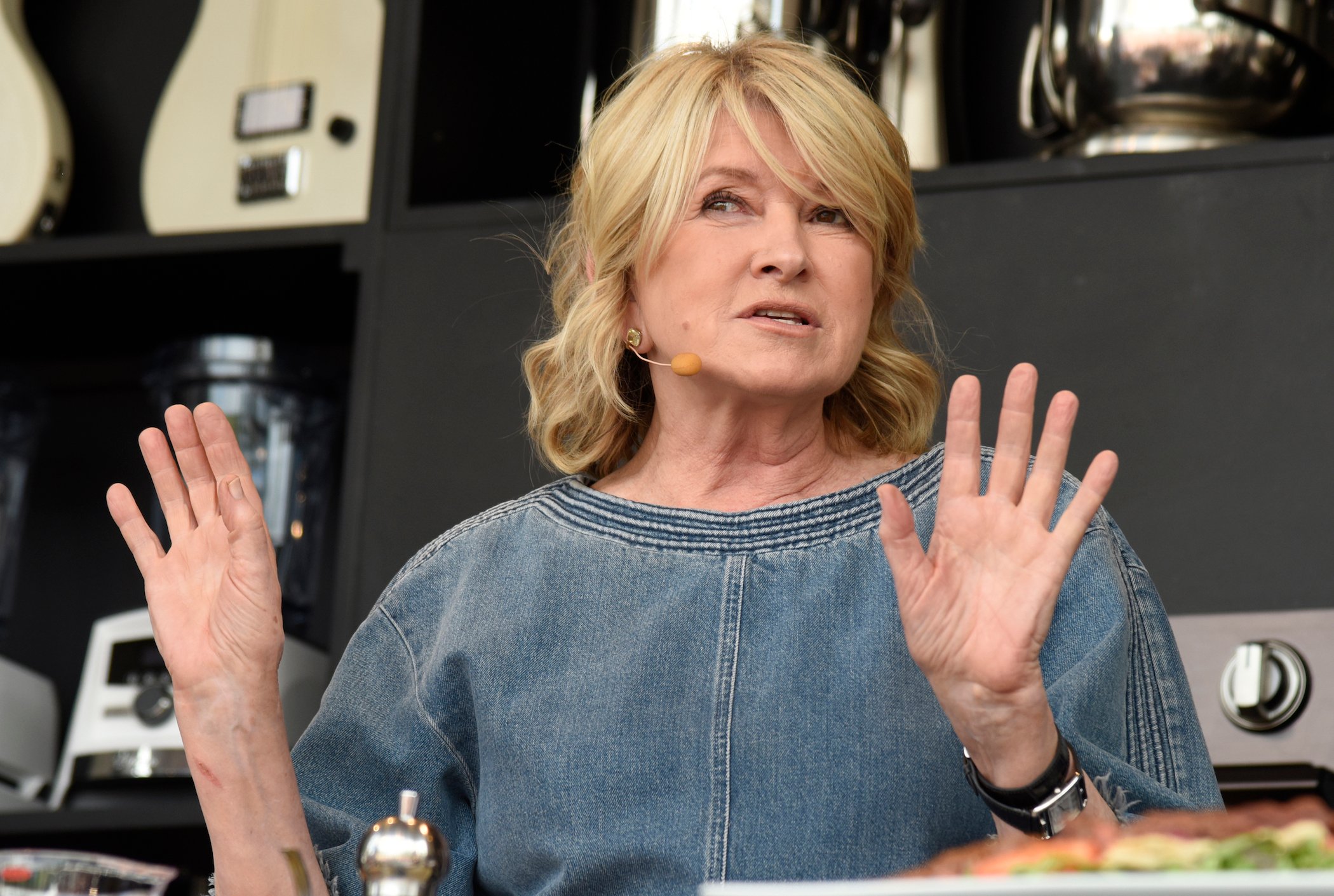 Martha Stewart, a famous cook known for her accessible recipes, speaking into a microphone at an event