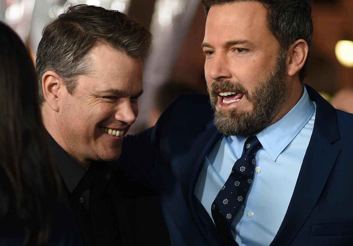Matt Damon and Ben Affleck wear suits and smile