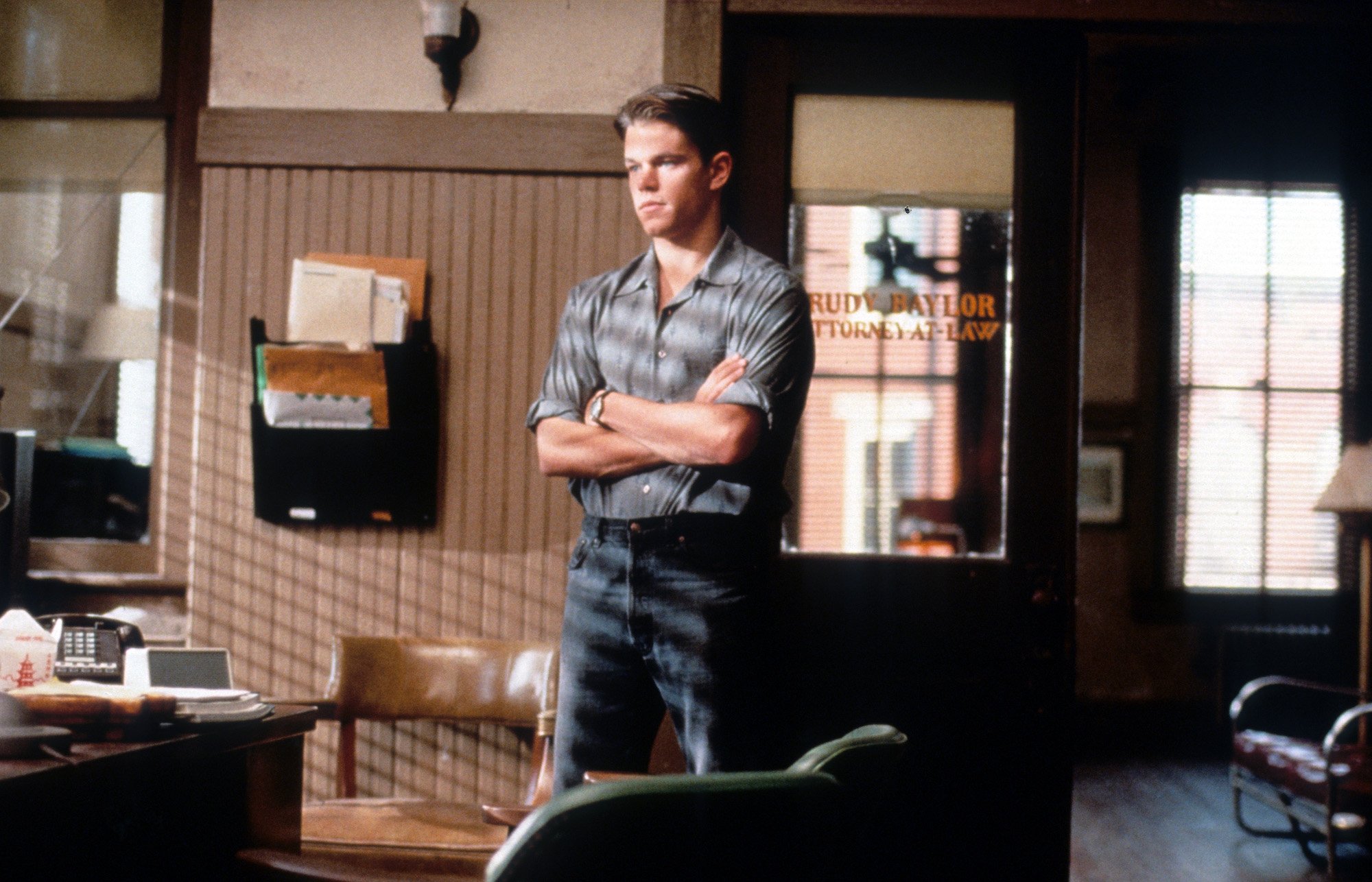 Matt Damon stands in his office in 'The Rainmaker'
