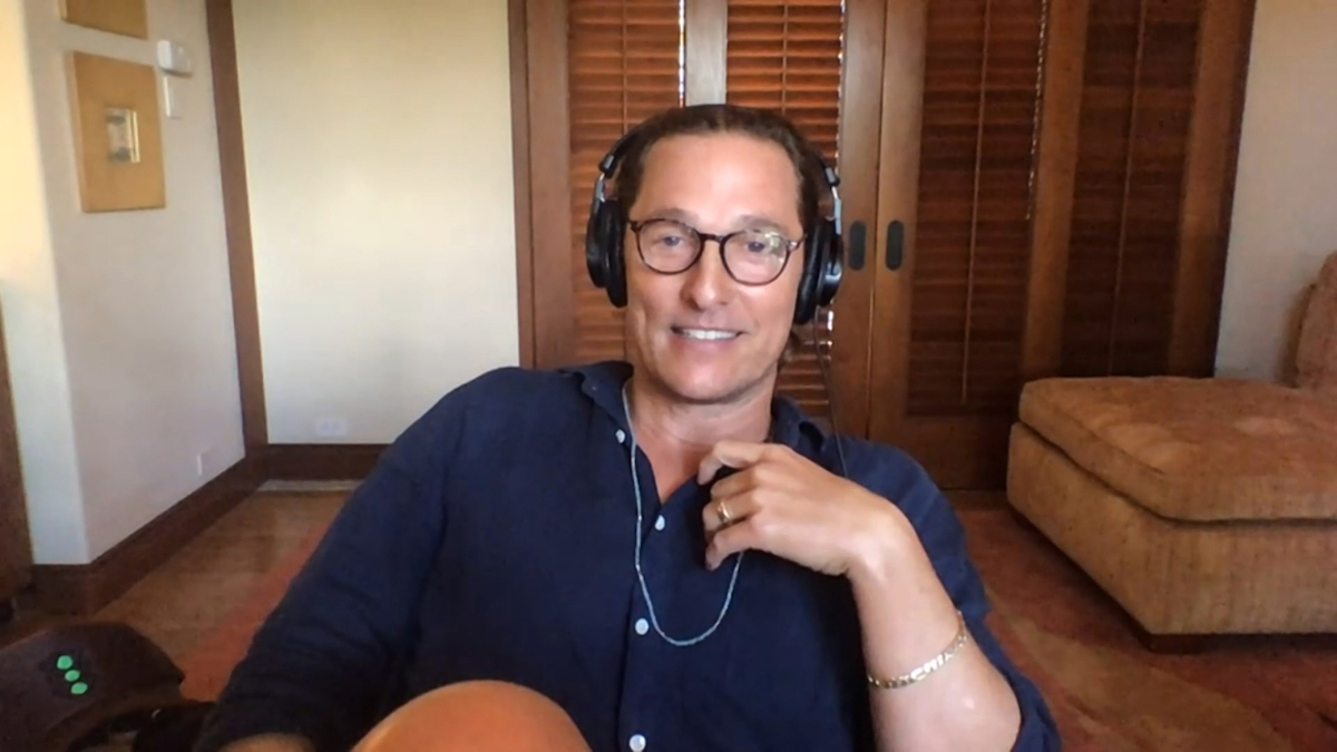 Matthew McConaughey wearing headphones sitting in a room
