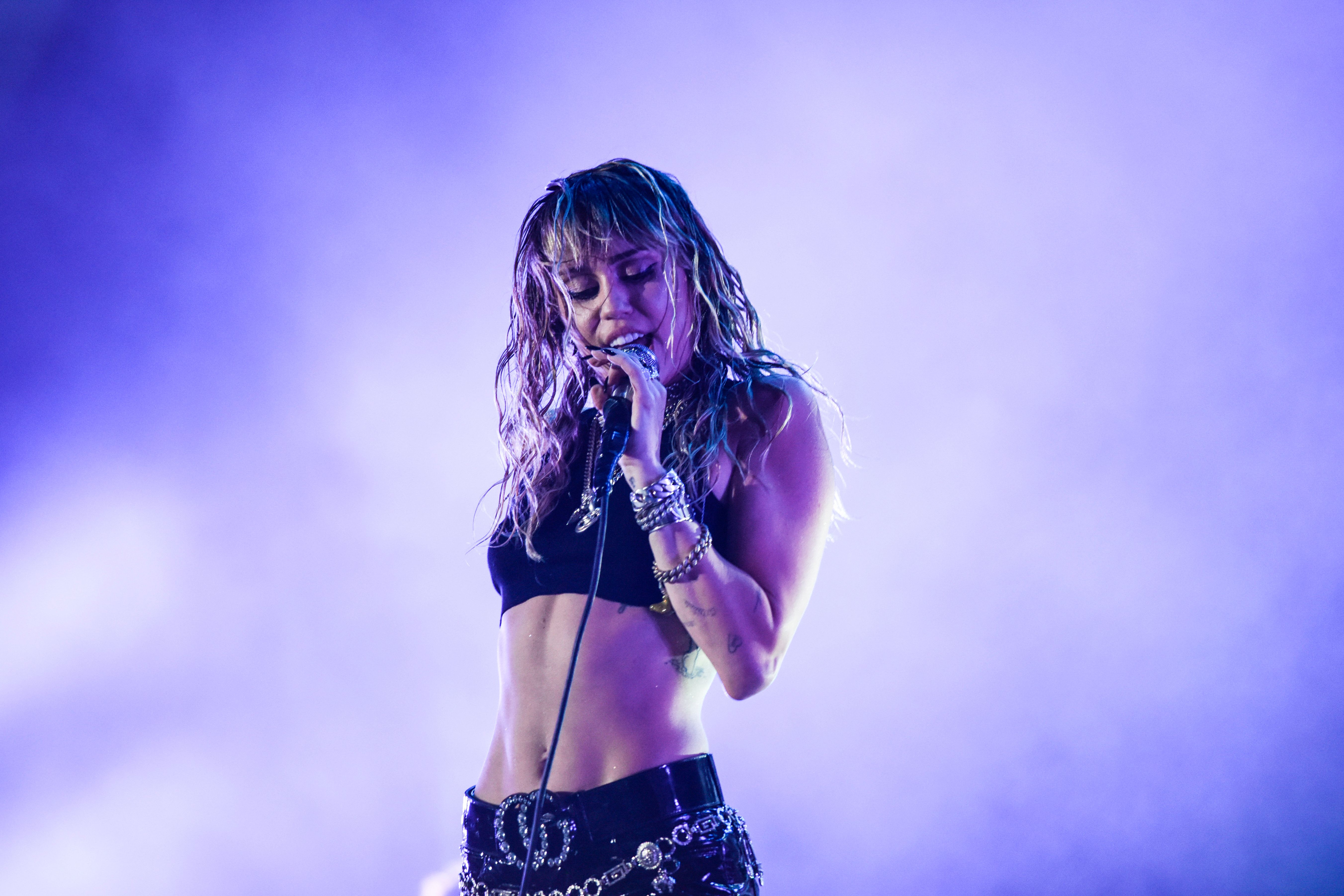 Miley Cyrus singing on stage during a concert at the Sunny Hill Festival