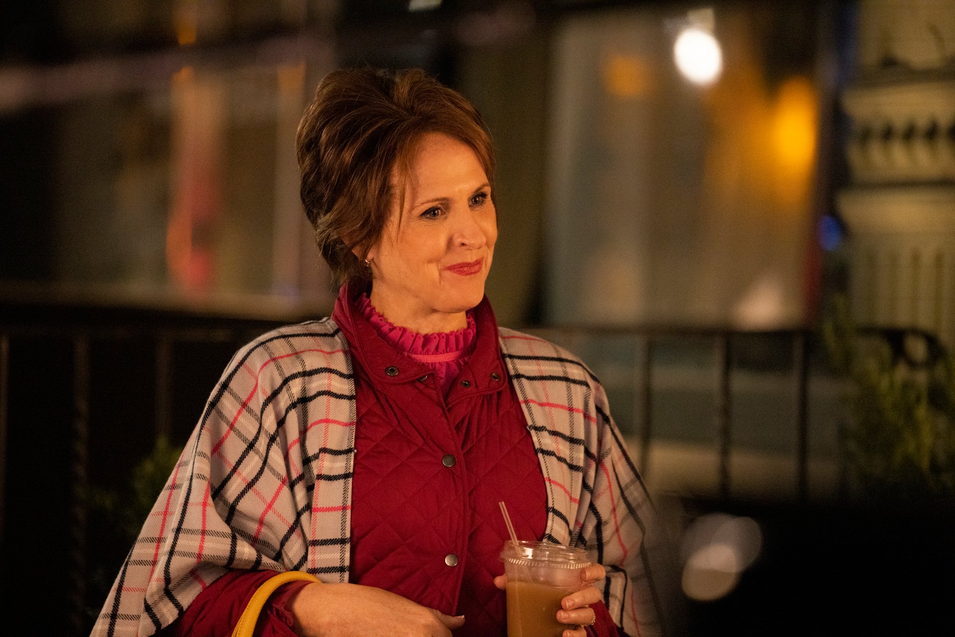 Molly Shannon wears a pink coat and plaid cape in 'The Other Two.'