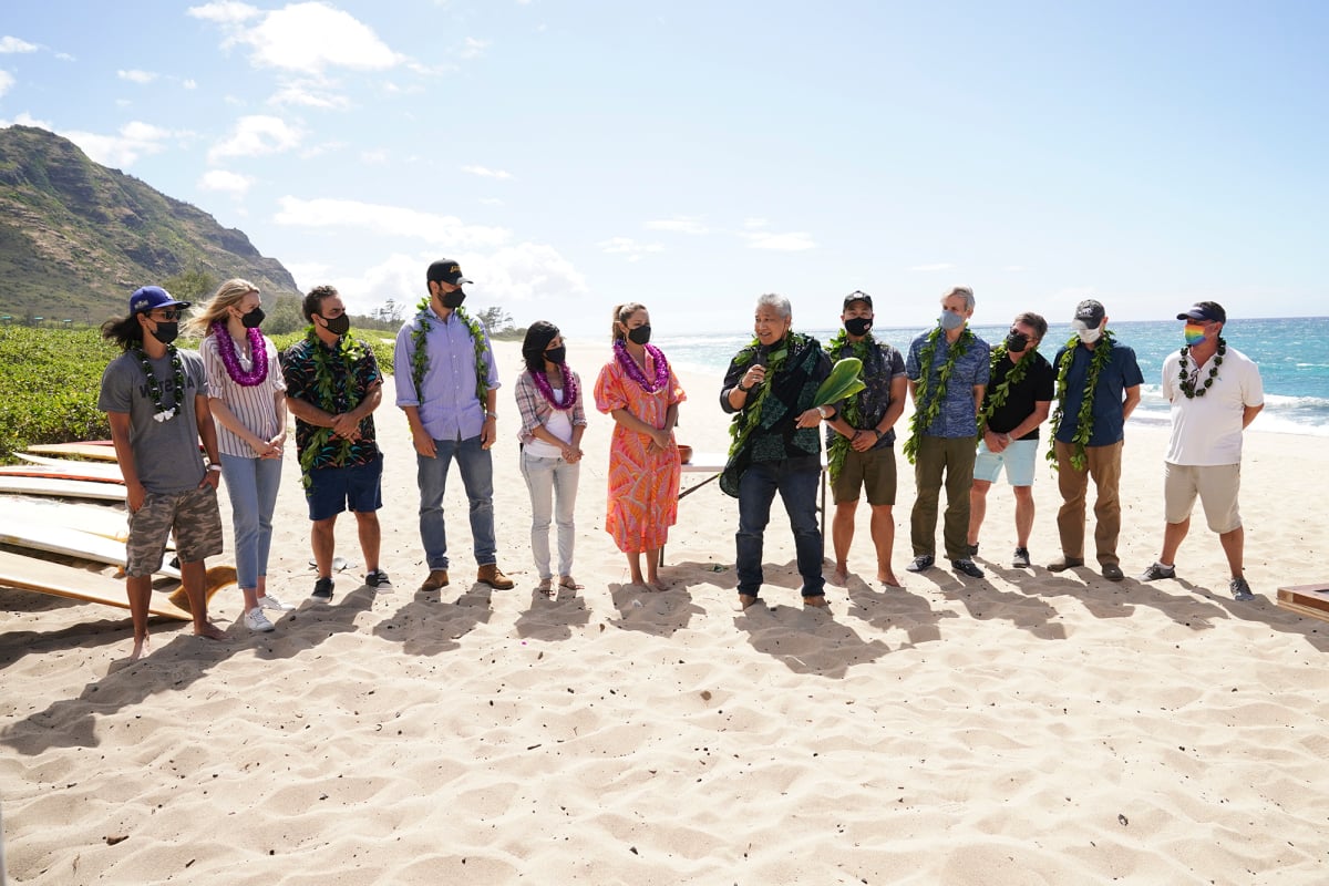 The NCIS: Hawaii cast stands on the beach.