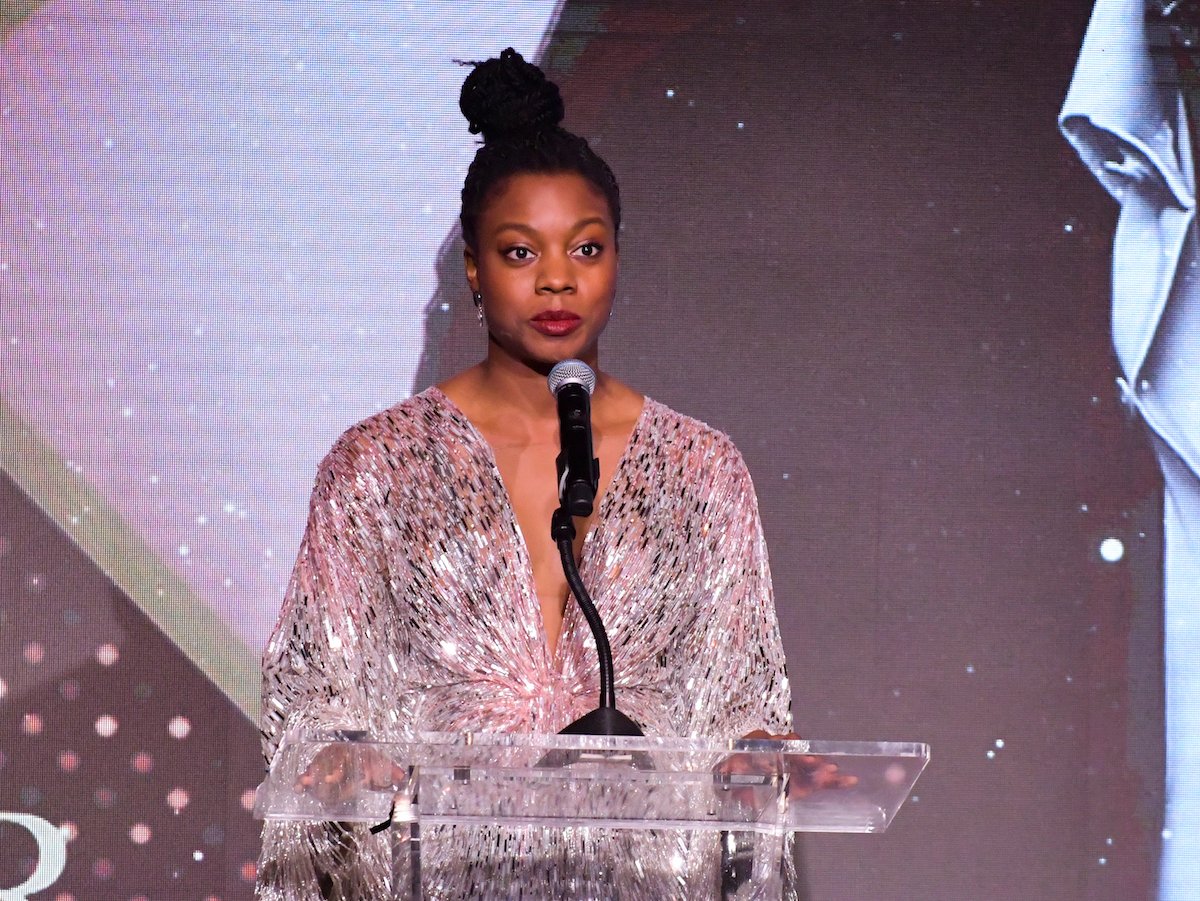 Nia DaCosta, director of 'Candyman,' in a shimmery gold dress at The African American Film Critics Association's 11th Annual AAFCA Awards.