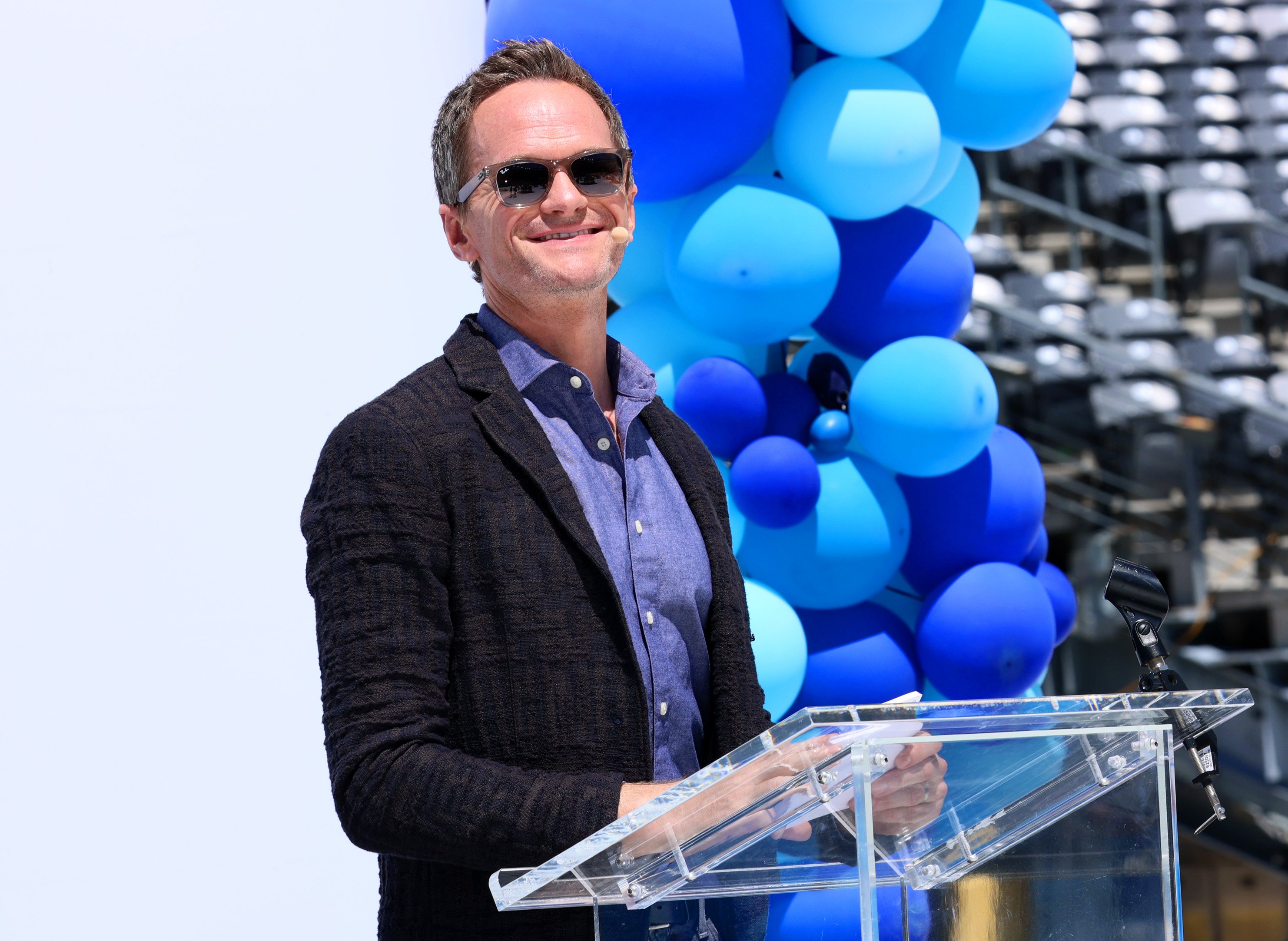 Neil Patrick Harris speaks at a podium