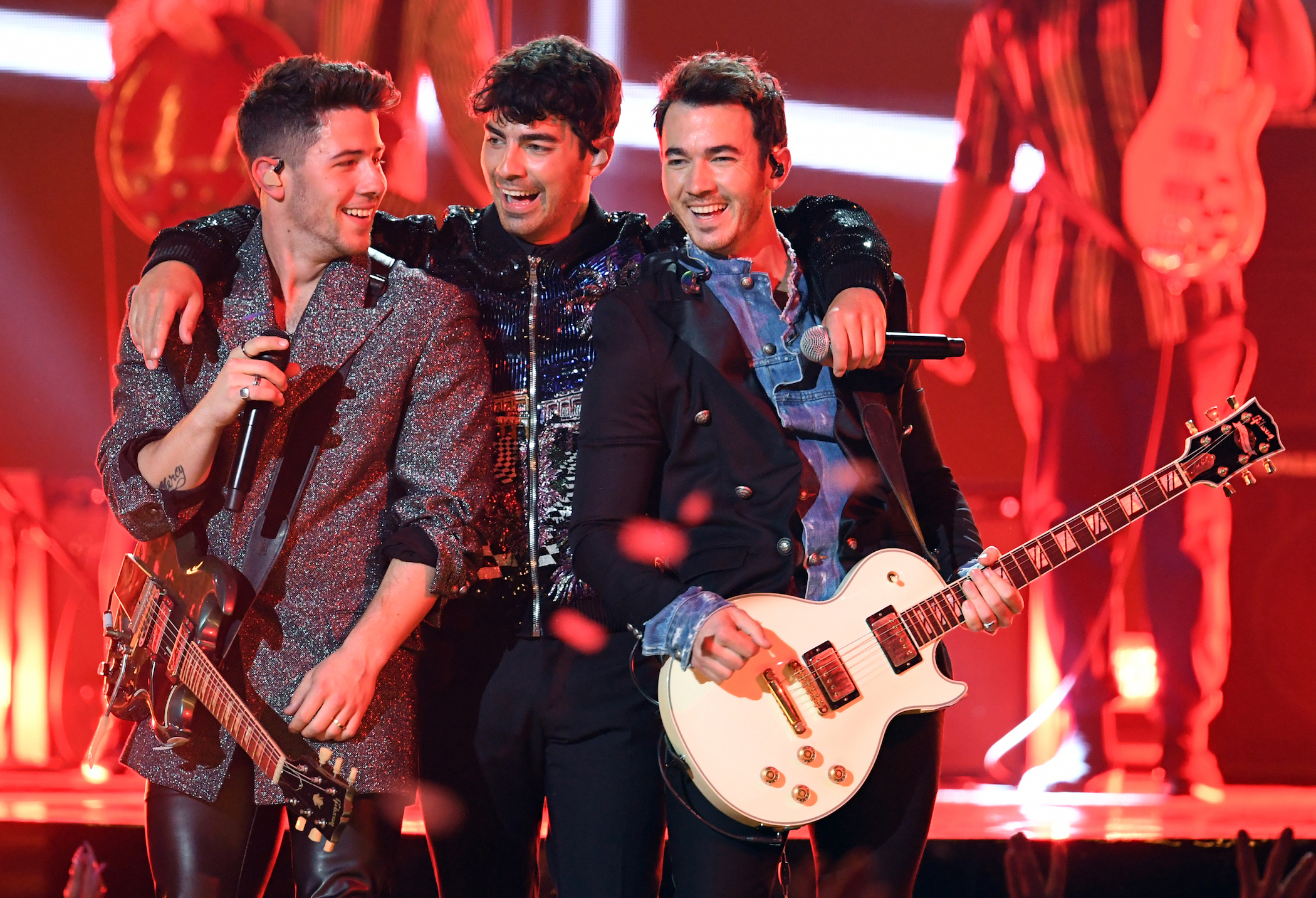 Nick, Joe, and Kevin Jonas performing onstage