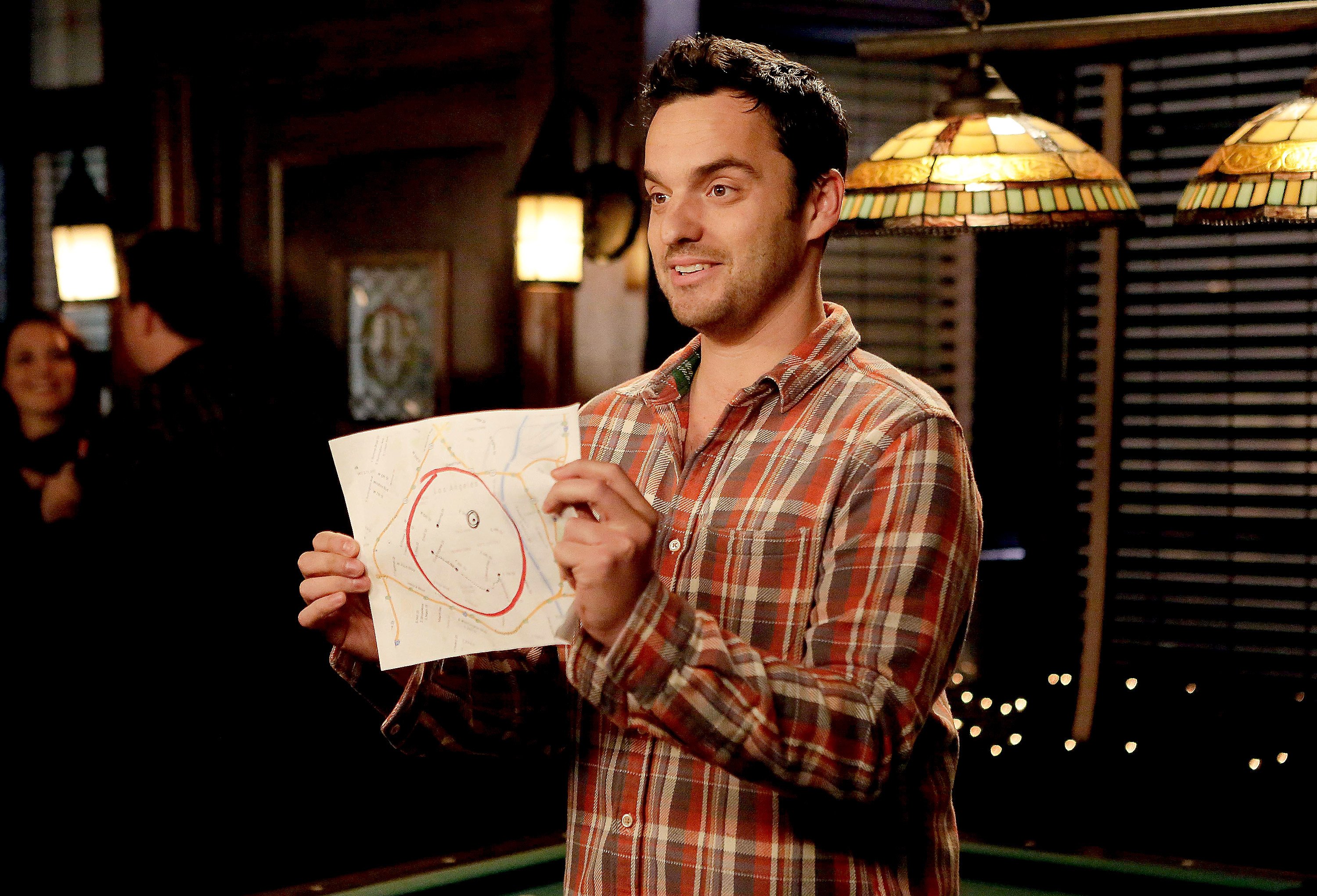 Nick from New Girl holds up a map of his bar crawl