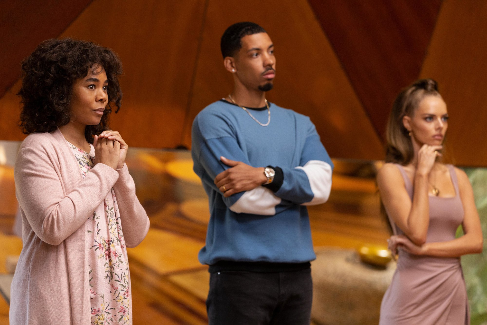 Carmel (Regina Hall), Ben (Melvin Gregg), and Jessica (Samara Weaving) from the cast of Hulu's 'Nine Perfect Strangers.' They're standing next to one another and looking confused at someone off-screen.