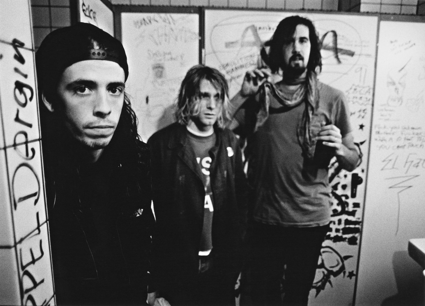 Nirvana drummer Dave Grohl, singer/guitarist Kurt Cobain, and bassist Krist Novoselic stand backstage in Frankfurt, Germany, in November 1991