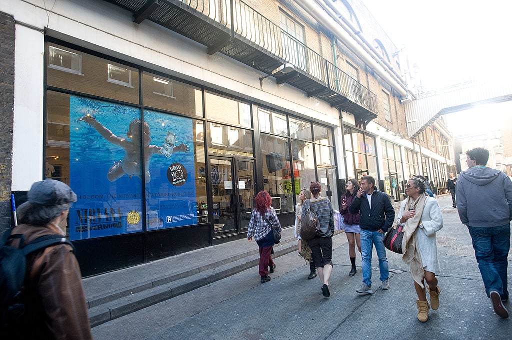 Passersby look at the giant album art for Nirvana's 'Nevermind' which is displayed on the window for the 20th anniversary exhibition.