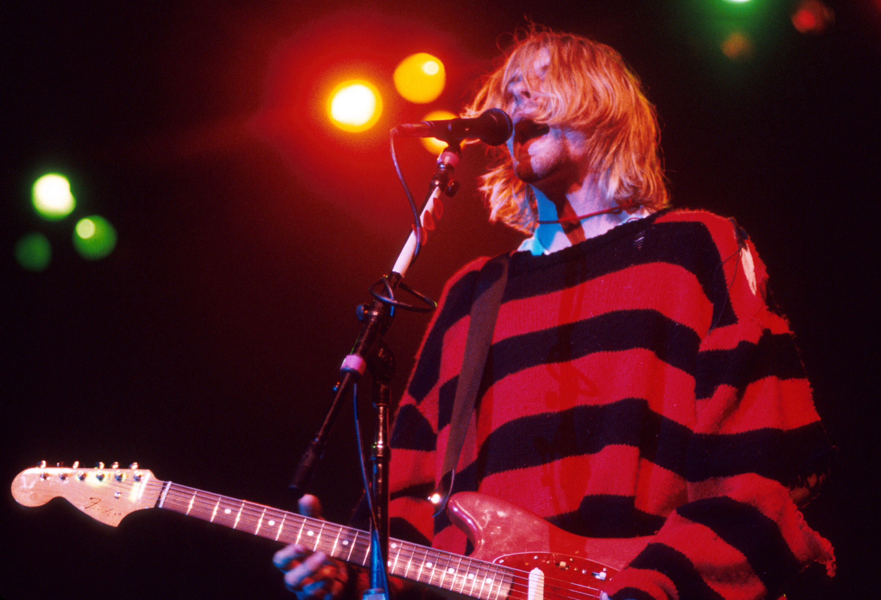 Nirvana's Kurt Cobain sings and plays guitar on stage
