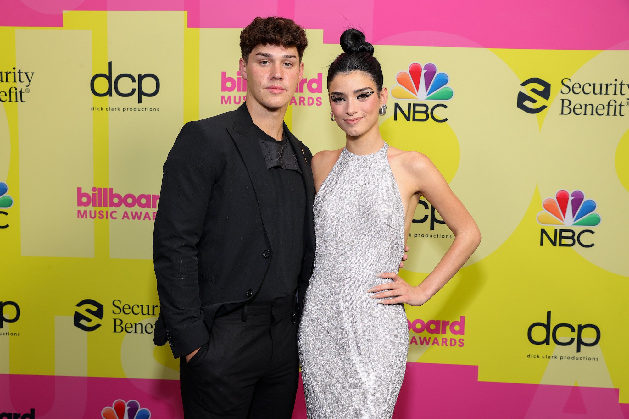 Noah Beck and Dixie D'Amelio posing on the red carpet at the 2021 Billboard Music Awards