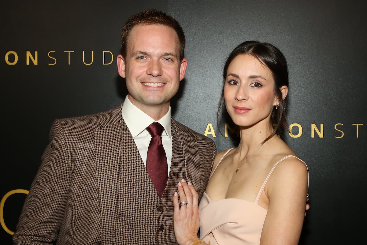 Troian Bellisario embraces her husband, Patrick J. Adams