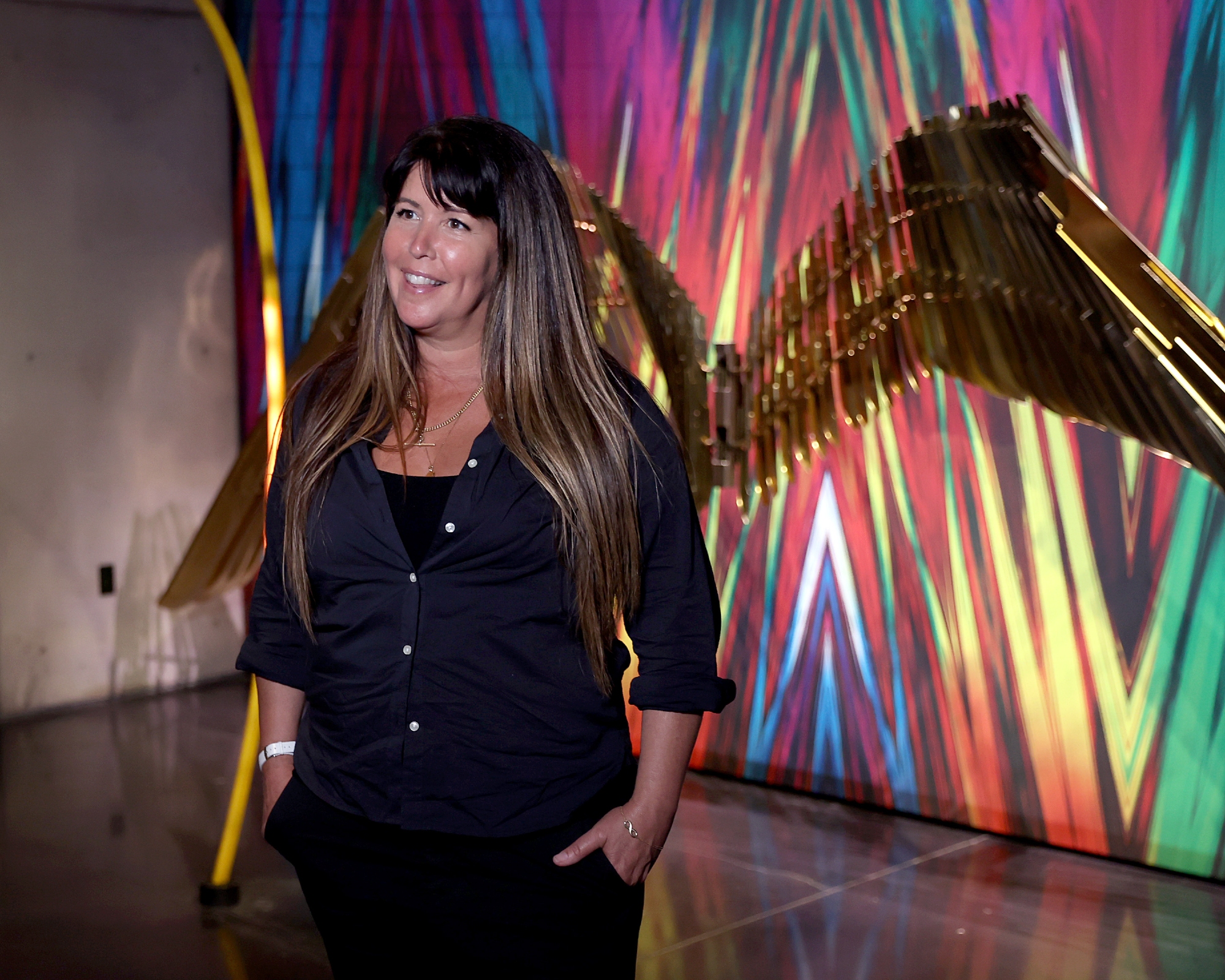 Patty Jenkins smiles in front of 'Wonder Woman 1984' exhibit during the Warner Bros. Studio Tour Hollywood Grand Re-Opening